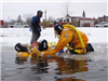 Firefighters prepare to remove a 'victim' from the icy water