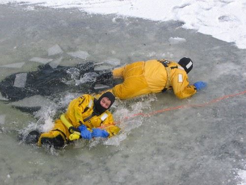 Firefighters practice pulling themselves out of the water